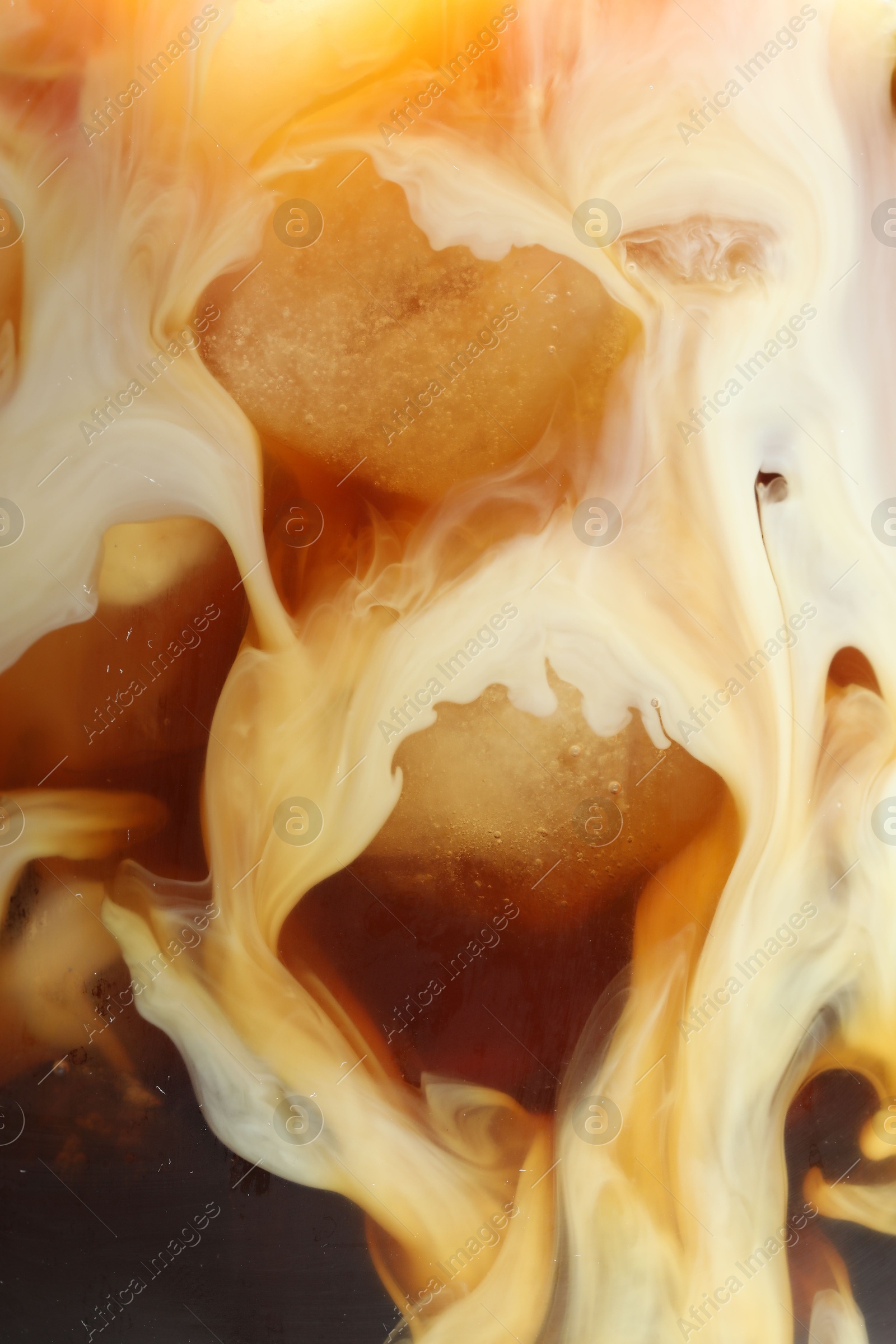 Photo of Refreshing coffee with ice and milk as background, closeup