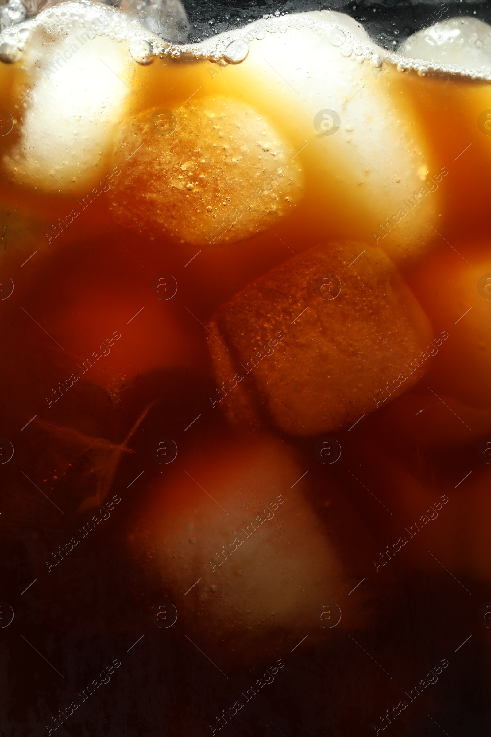 Photo of Refreshing coffee with ice cubes as background, closeup