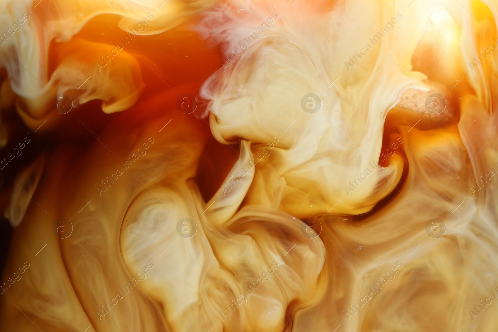 Photo of Refreshing coffee with ice and milk as background, closeup