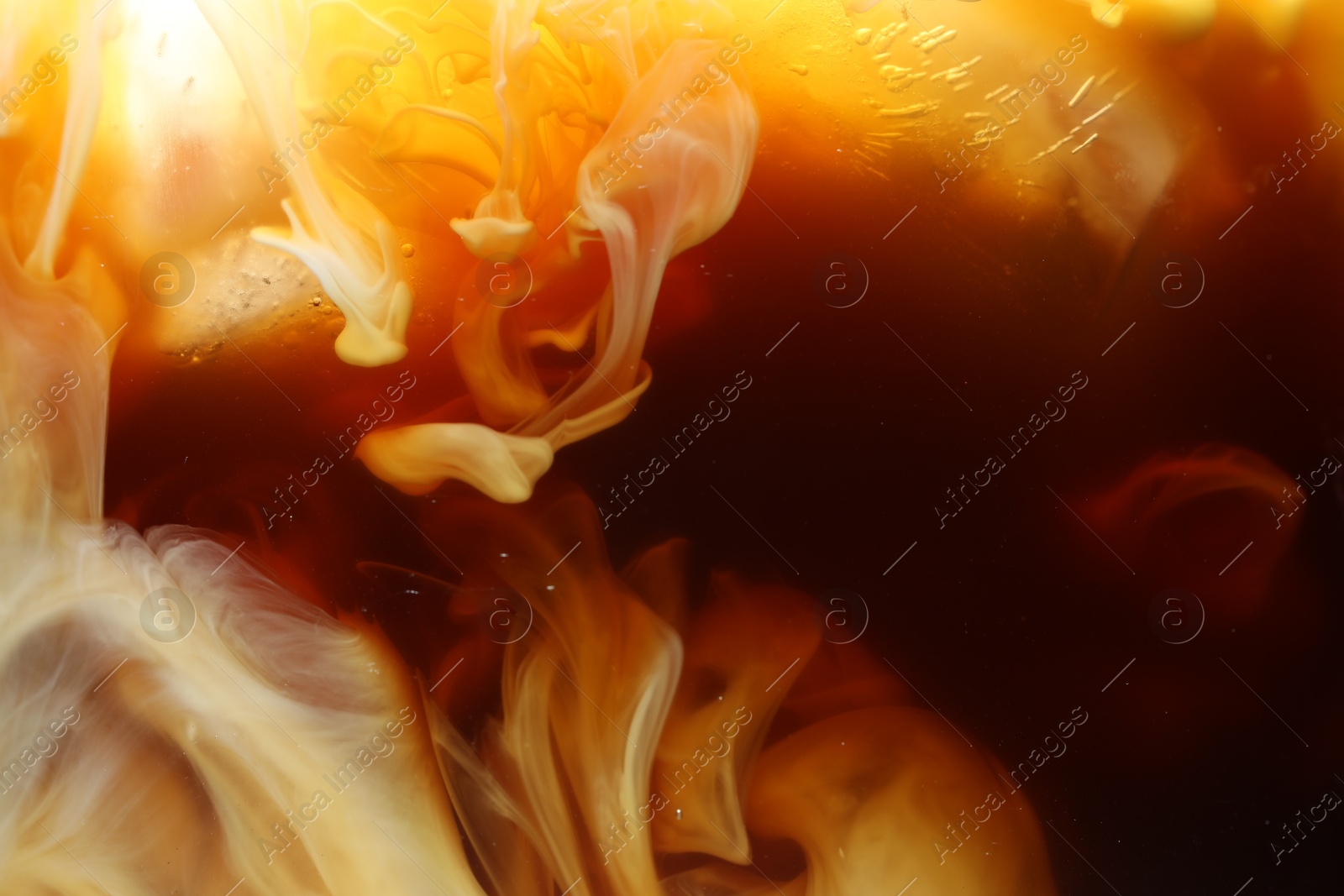 Photo of Refreshing coffee with ice and milk as background, closeup