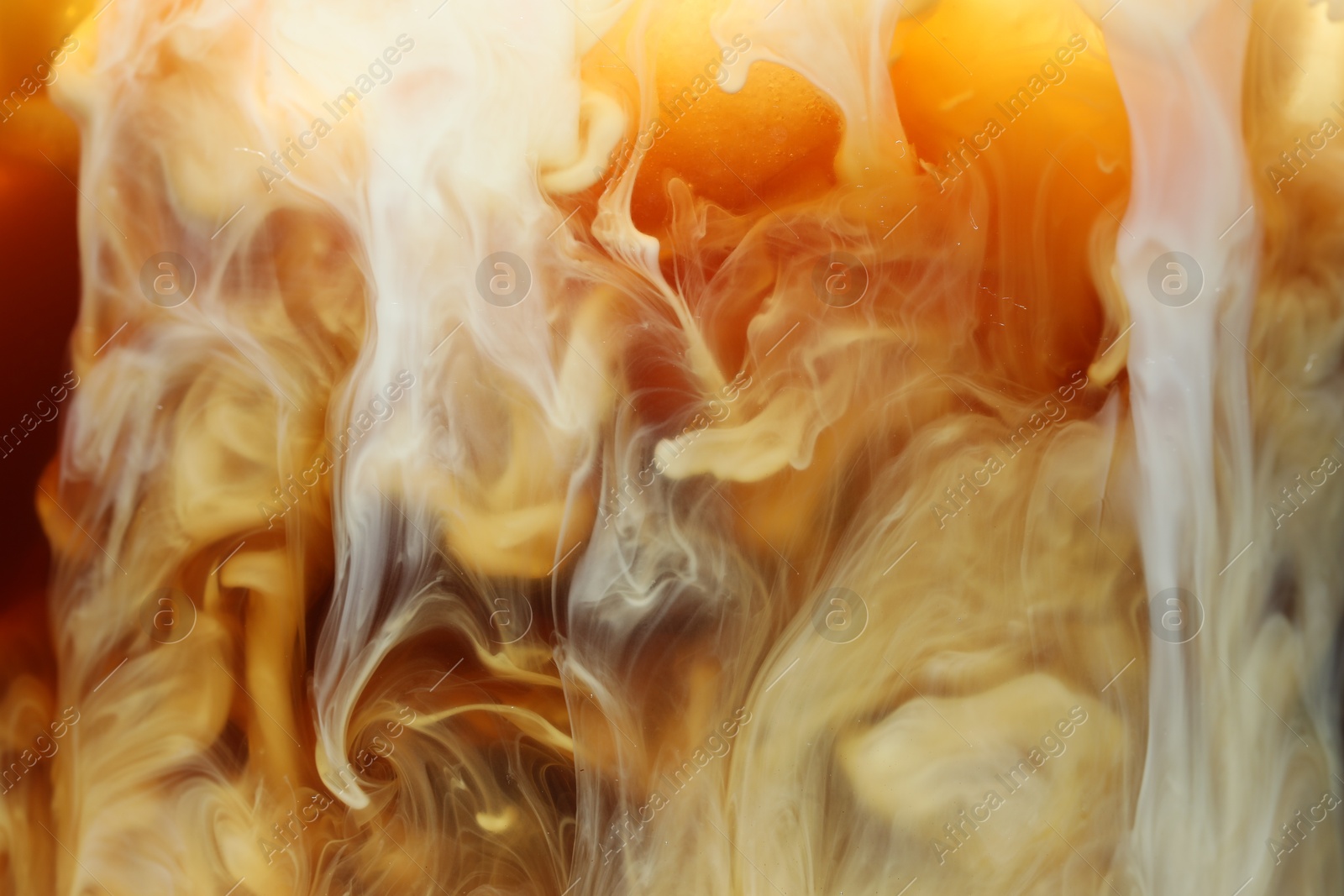 Photo of Refreshing coffee with ice and milk as background, closeup