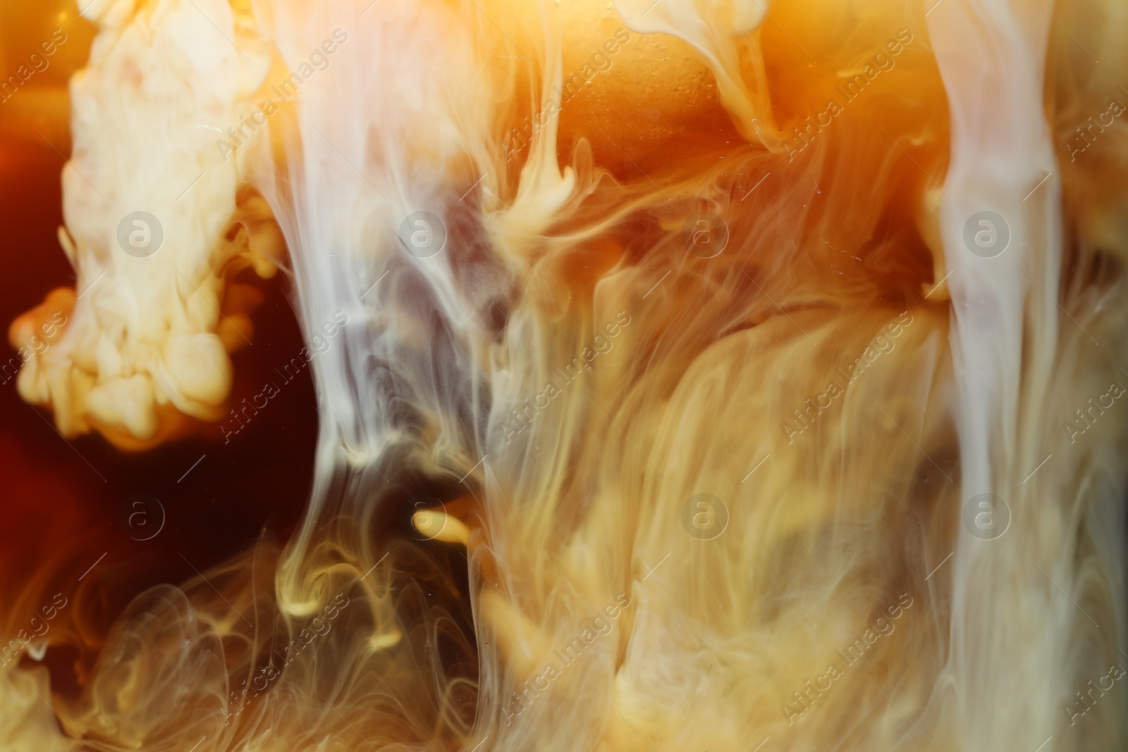 Photo of Refreshing coffee with ice and milk as background, closeup