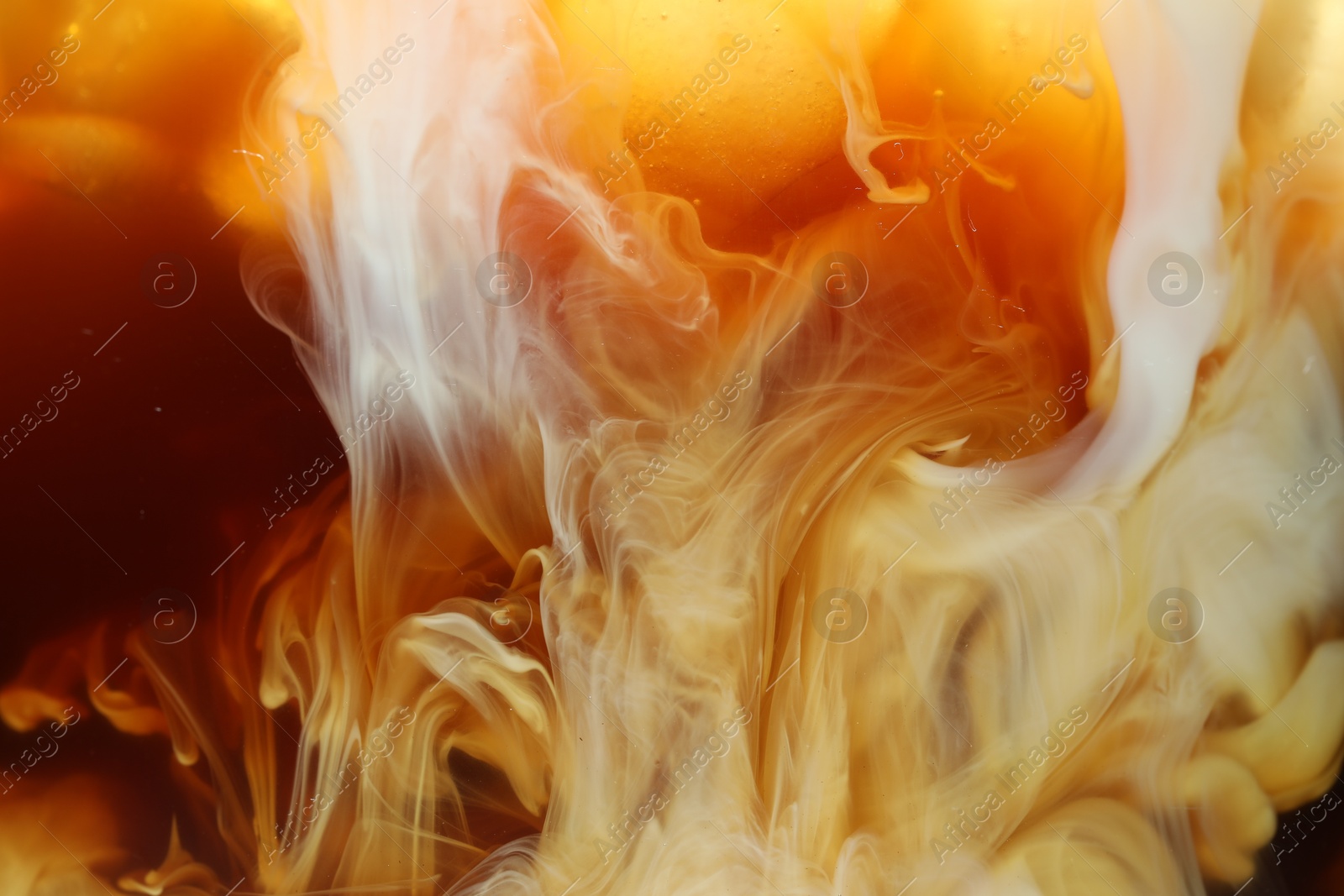 Photo of Refreshing coffee with ice and milk as background, closeup