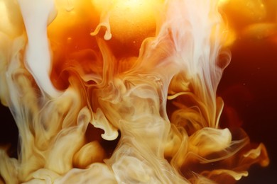 Photo of Refreshing coffee with ice and milk as background, closeup