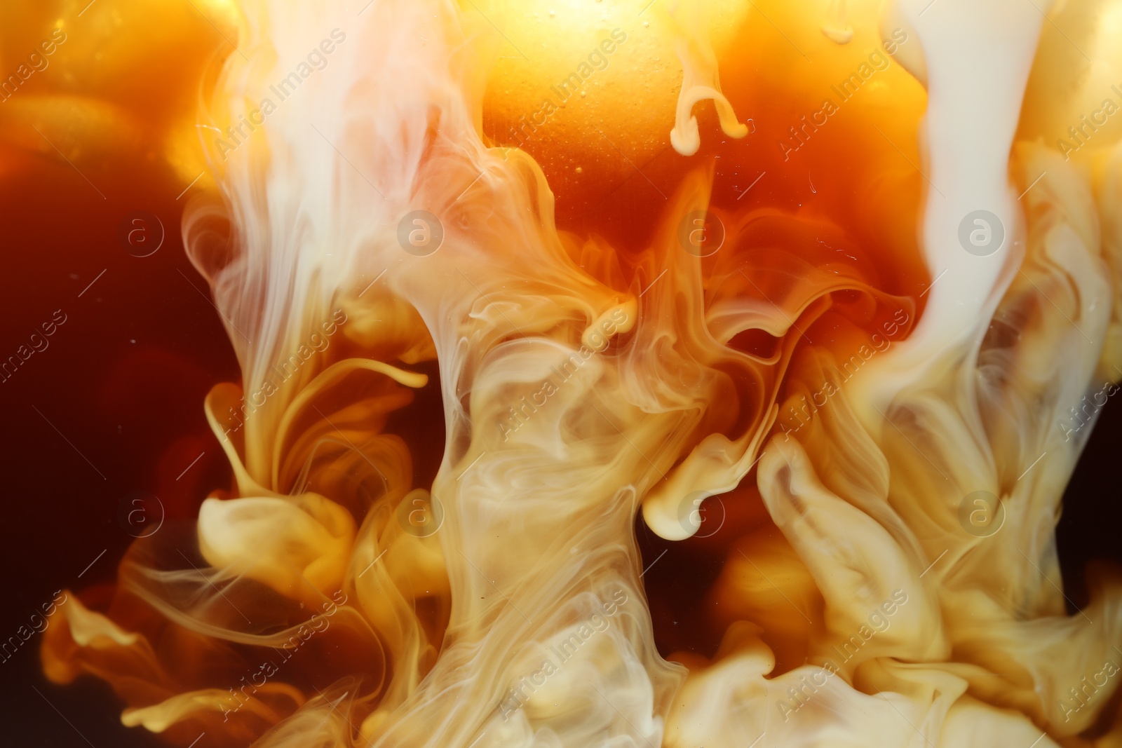 Photo of Refreshing coffee with ice and milk as background, closeup