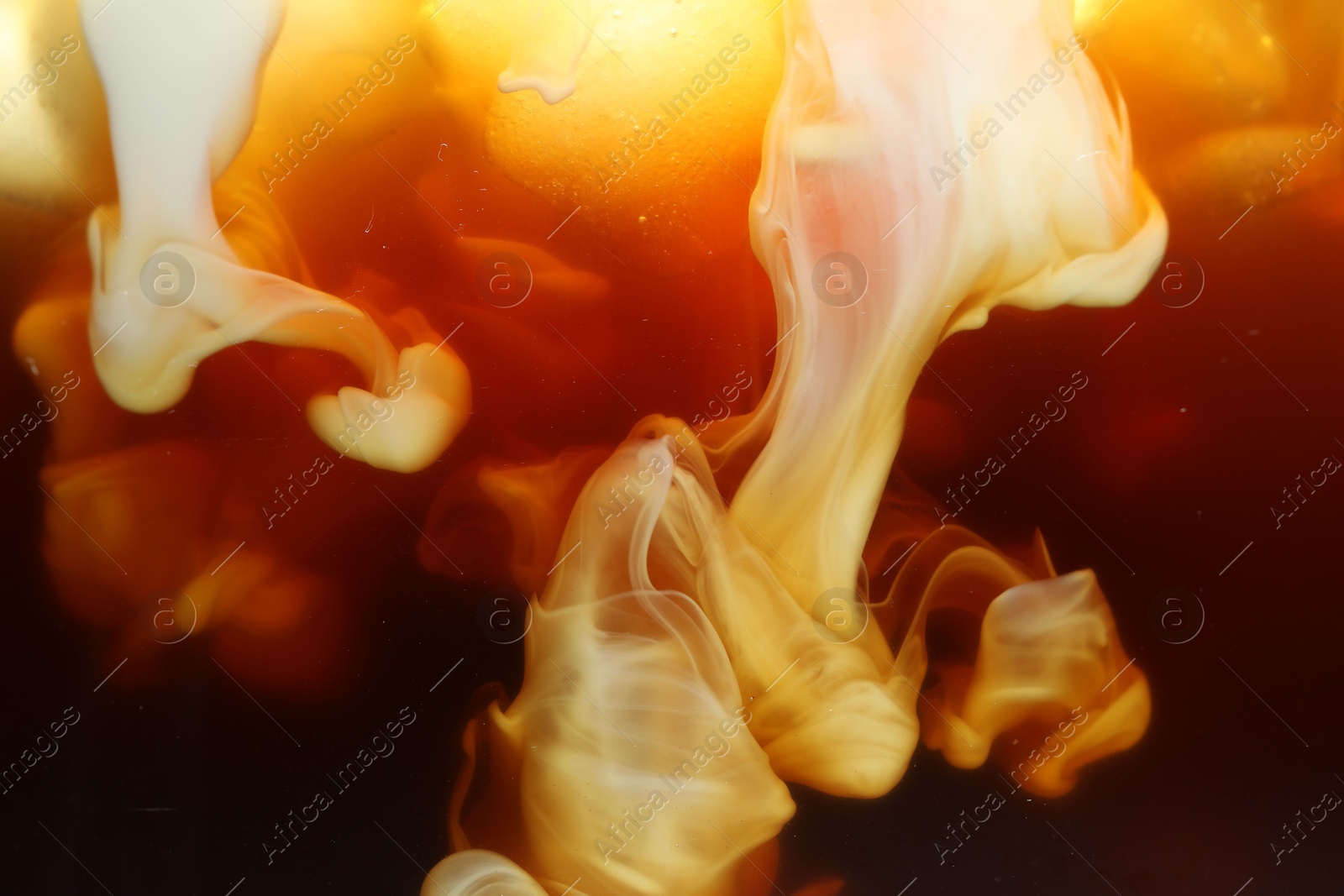 Photo of Refreshing coffee with ice and milk as background, closeup