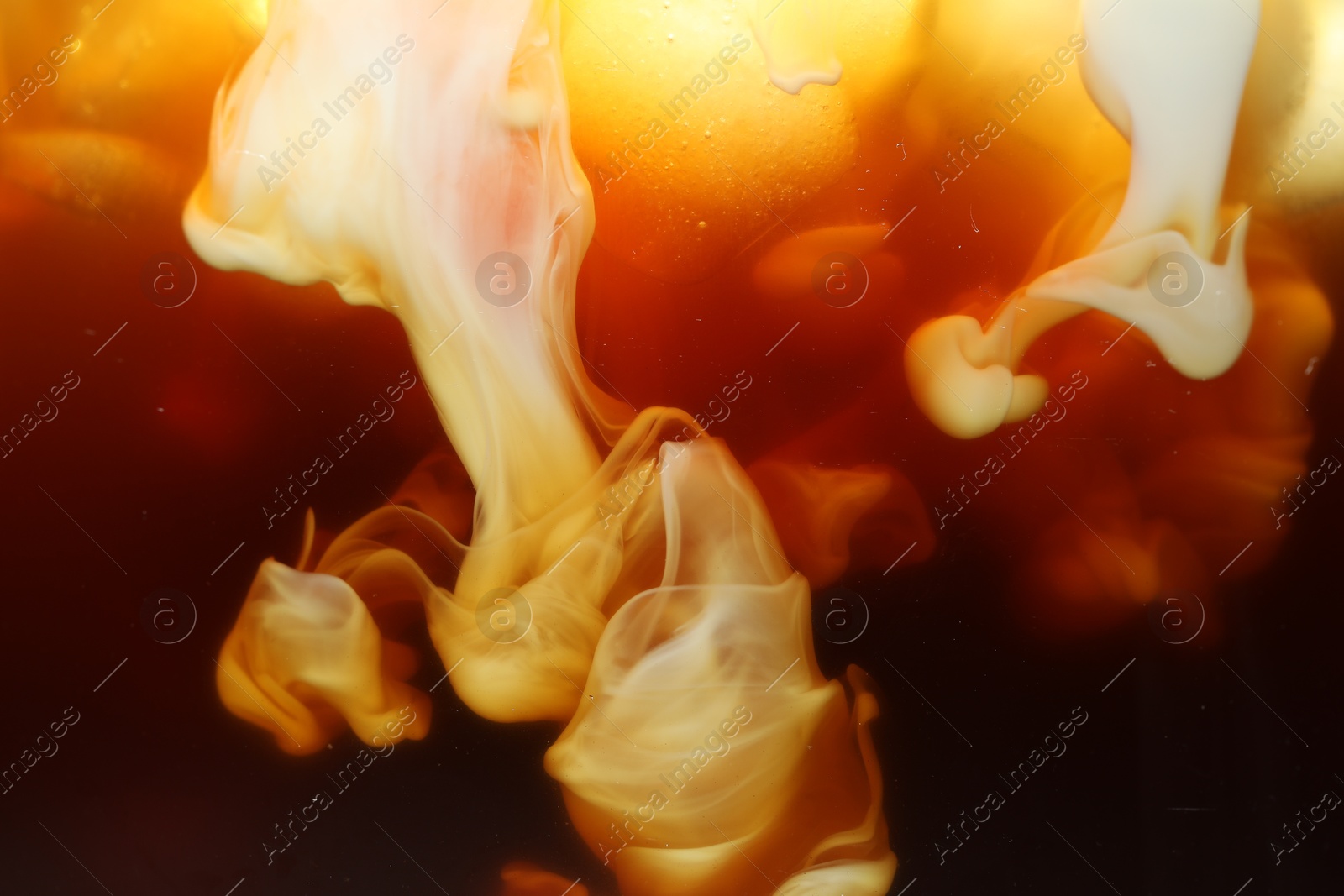 Photo of Refreshing coffee with ice and milk as background, closeup