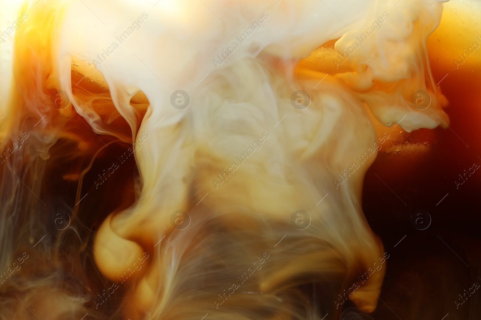 Photo of Refreshing coffee with ice and milk as background, closeup