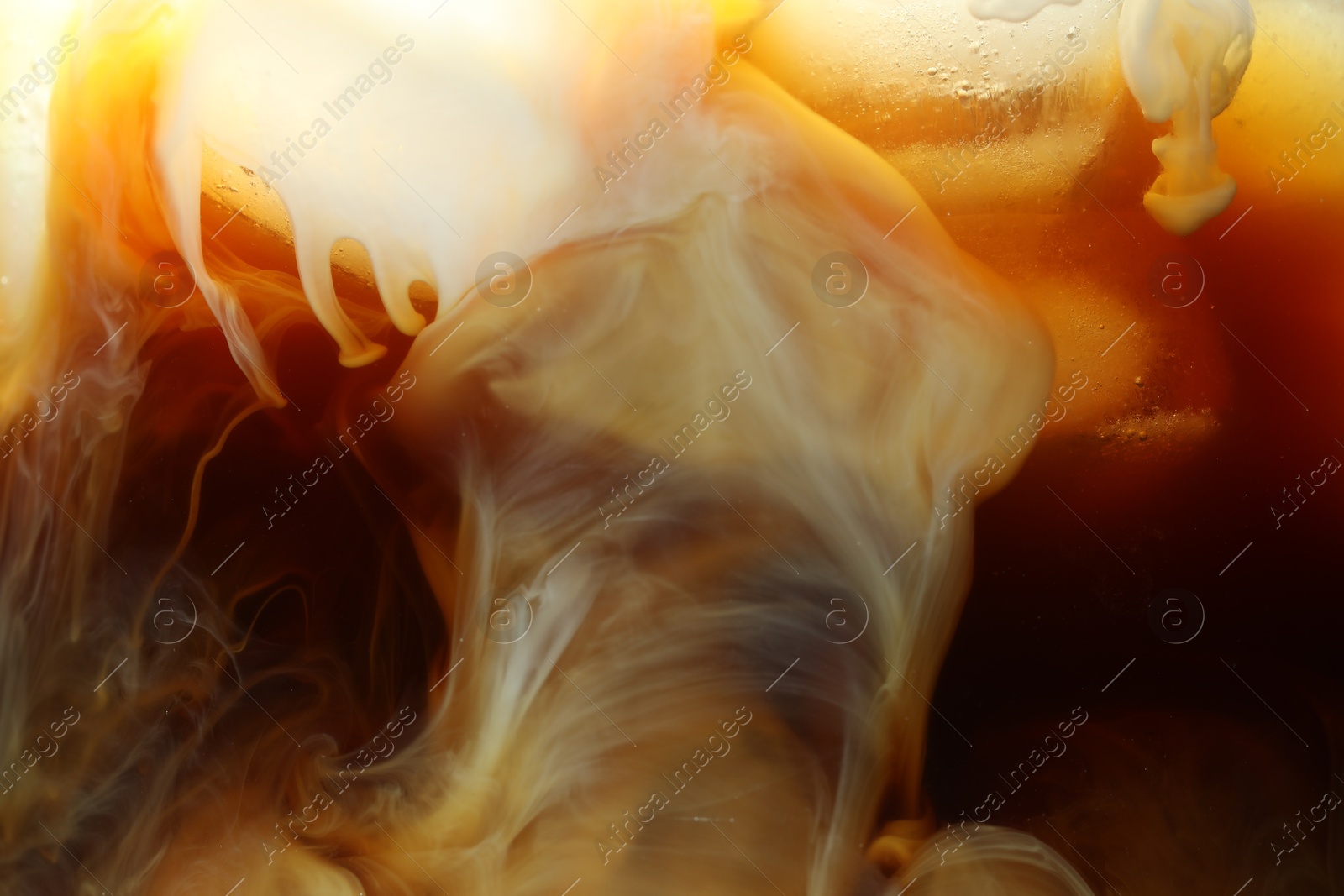 Photo of Refreshing coffee with ice and milk as background, closeup