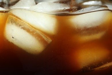 Photo of Refreshing coffee with ice cubes as background, closeup