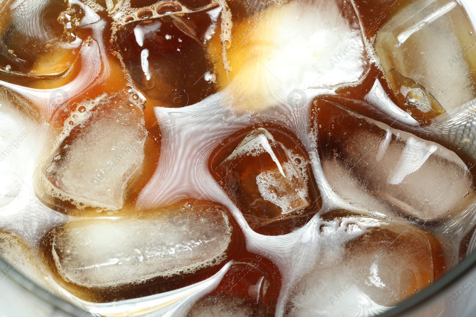 Photo of Refreshing coffee with ice and milk in glass, top view