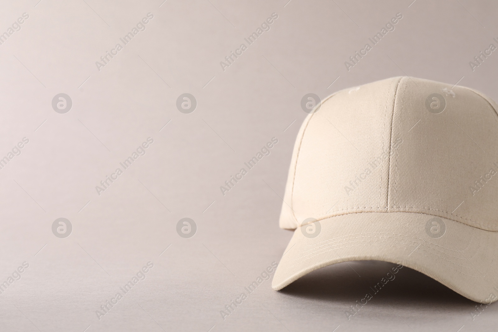 Photo of Stylish baseball cap on light grey background, closeup. Mockup for design