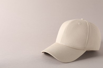 Photo of Stylish baseball cap on light grey background. Mockup for design