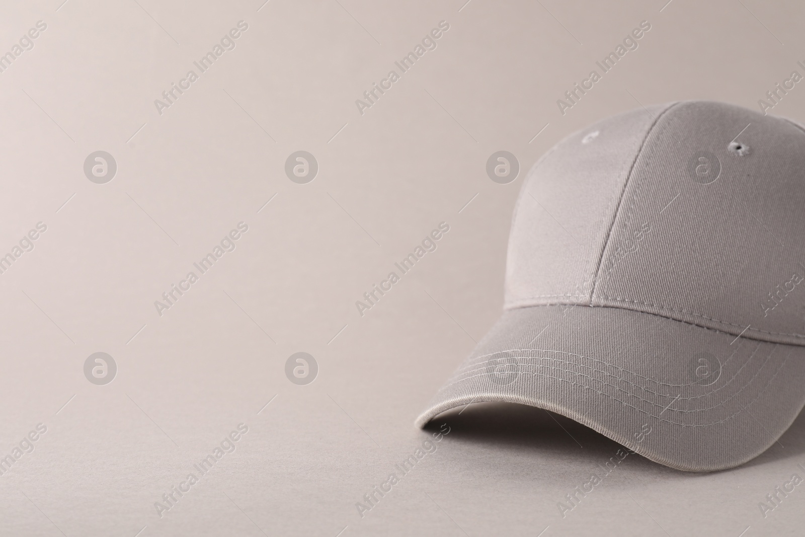 Photo of Stylish baseball cap on light grey background, closeup. Mockup for design