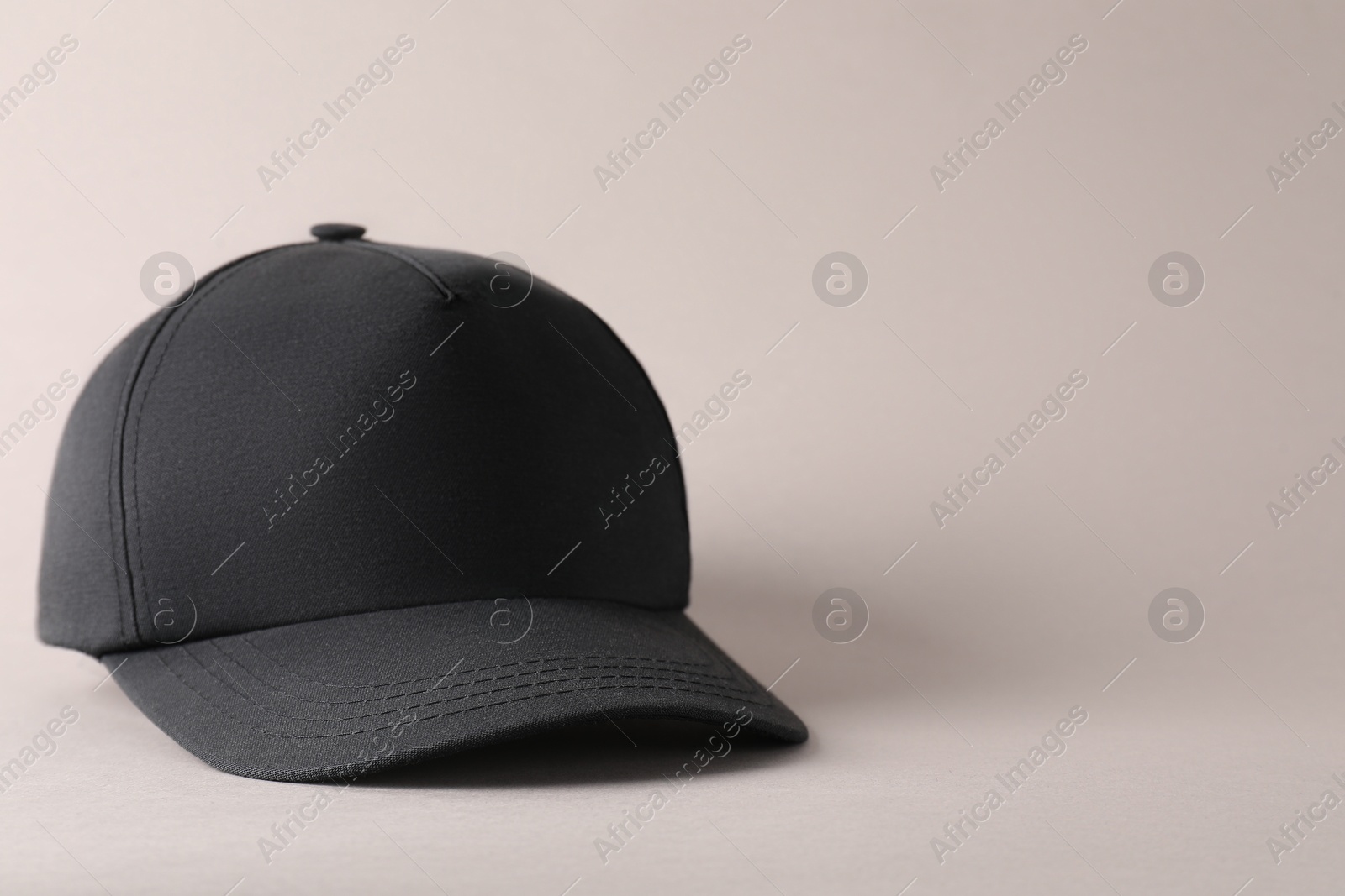 Photo of Stylish black baseball cap on light grey background. Mockup for design