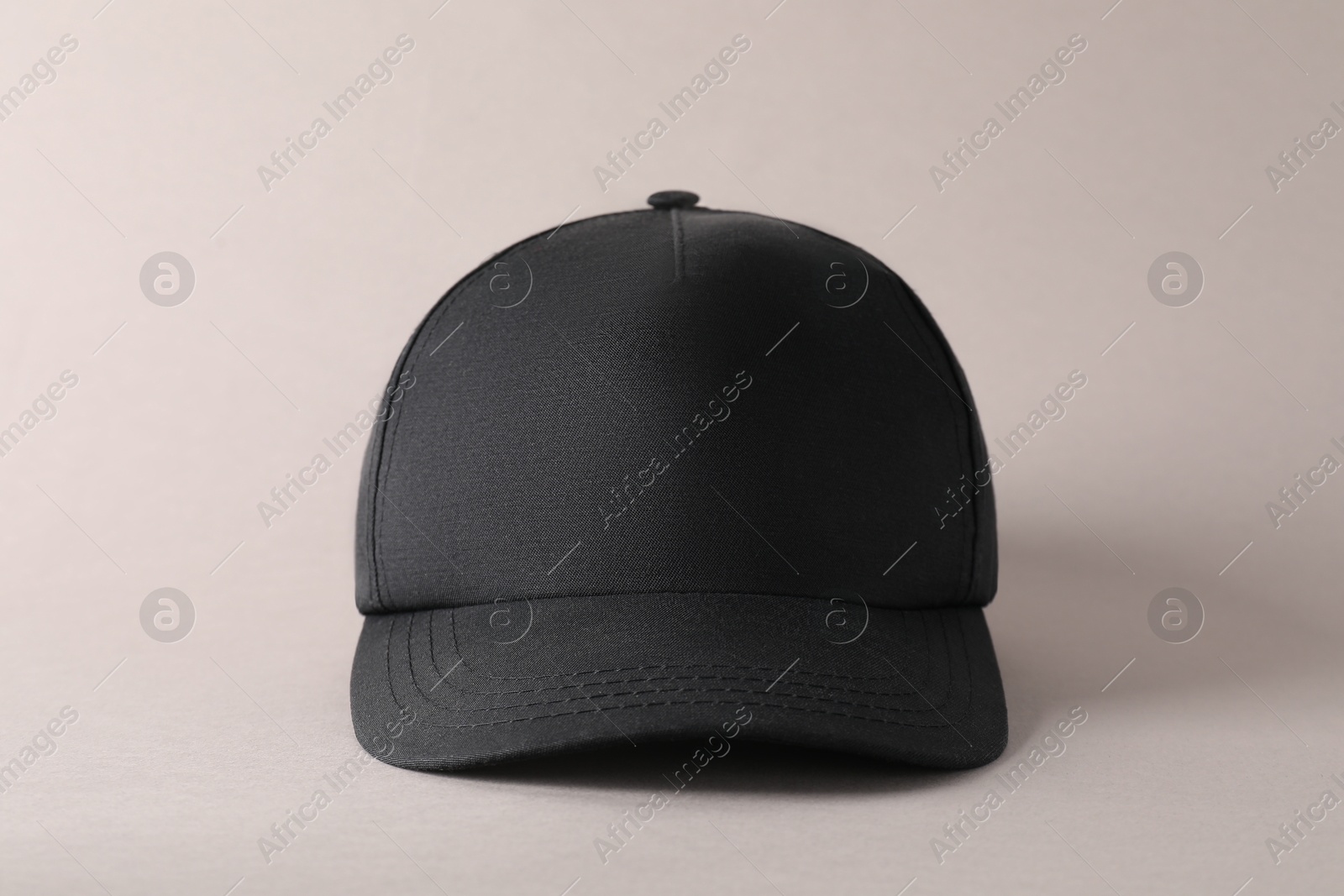 Photo of Stylish black baseball cap on light grey background. Mockup for design