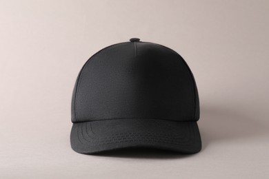 Photo of Stylish black baseball cap on light grey background. Mockup for design