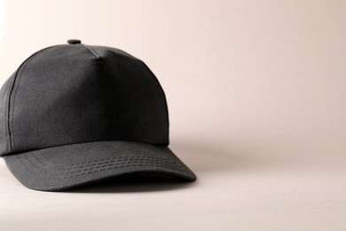 Photo of Stylish black baseball cap on light grey background. Mockup for design