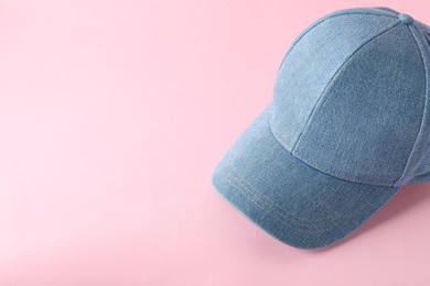 Photo of Stylish denim baseball cap on pink background. Mockup for design