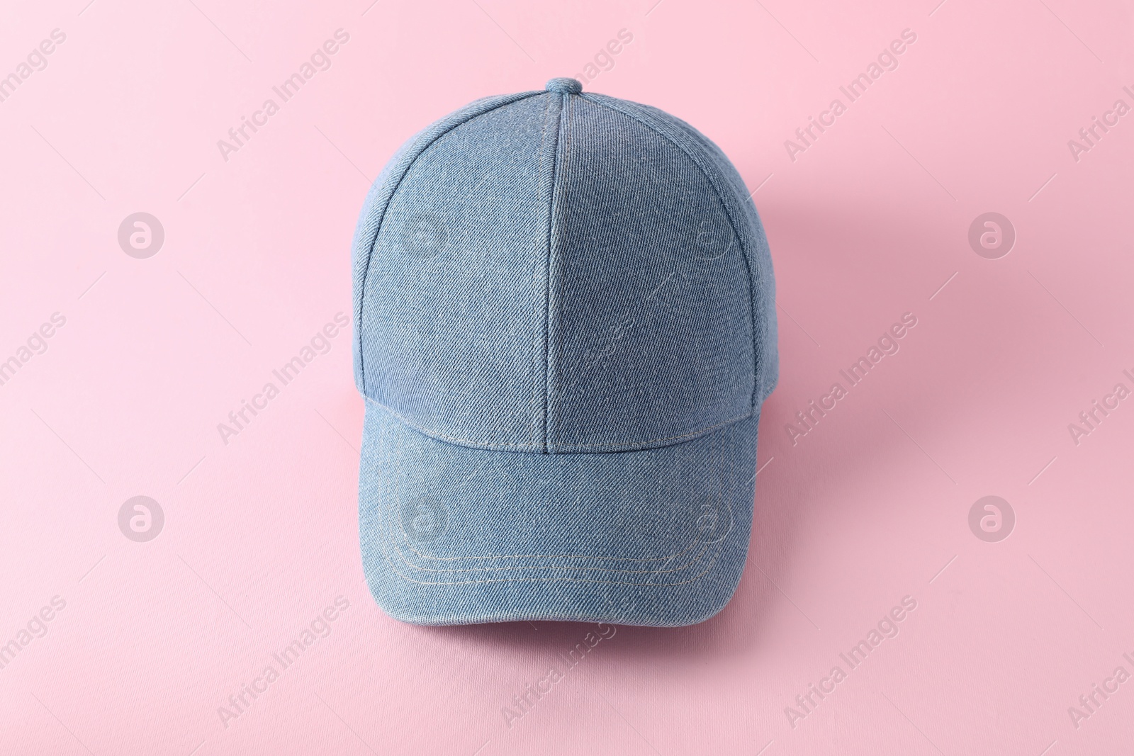 Photo of Stylish denim baseball cap on pink background. Mockup for design