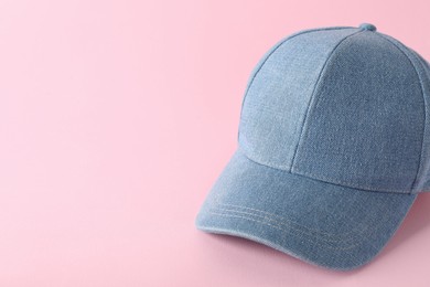 Photo of Stylish denim baseball cap on pink background. Mockup for design