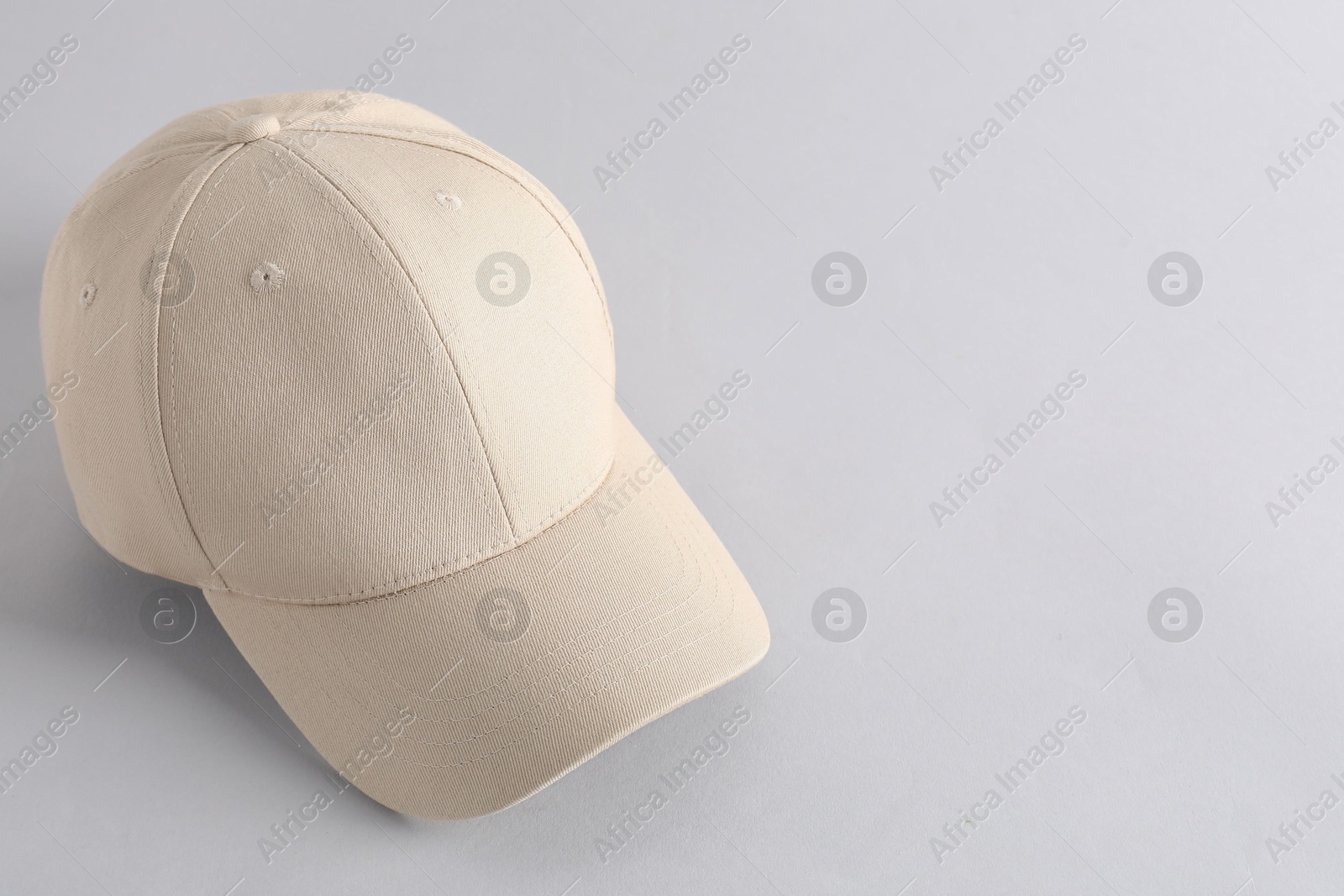 Photo of Stylish baseball cap on light grey background. Mockup for design