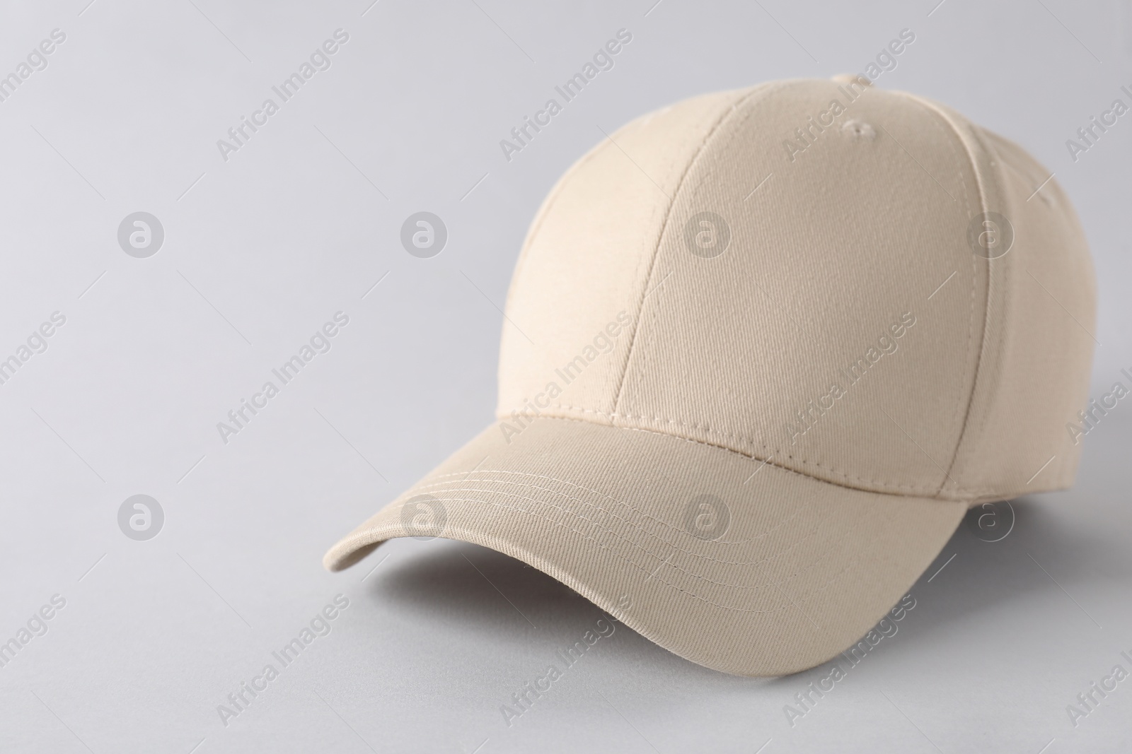 Photo of Stylish baseball cap on light grey background, closeup. Mockup for design