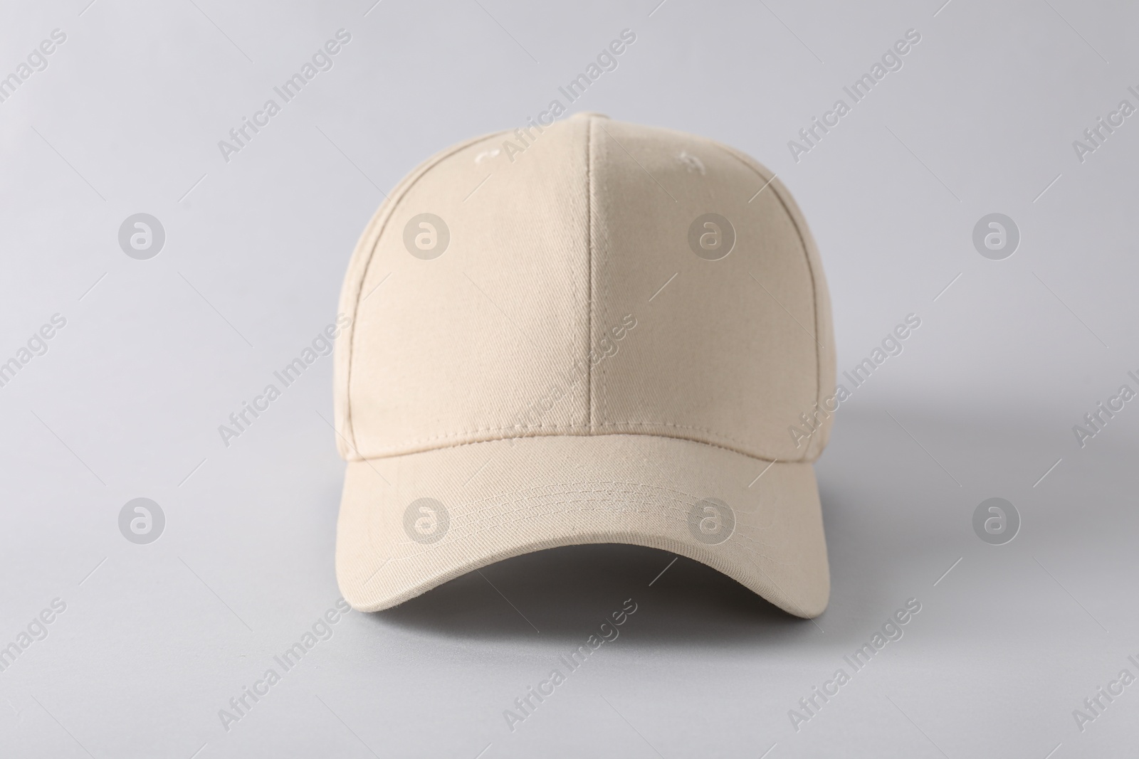 Photo of Stylish baseball cap on light grey background. Mockup for design