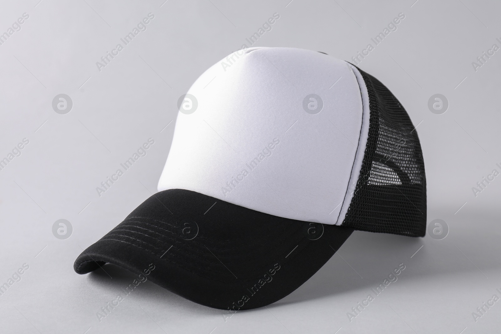 Photo of Stylish baseball cap on light grey background, closeup. Mockup for design