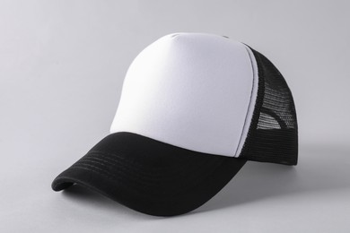 Photo of Stylish baseball cap on light grey background, closeup. Mockup for design