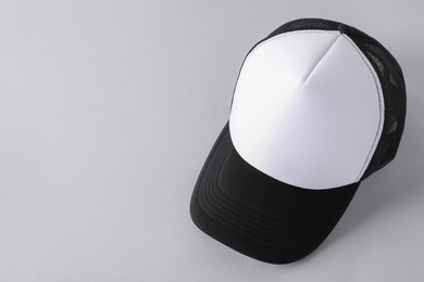 Photo of Stylish baseball cap on light grey background. Mockup for design