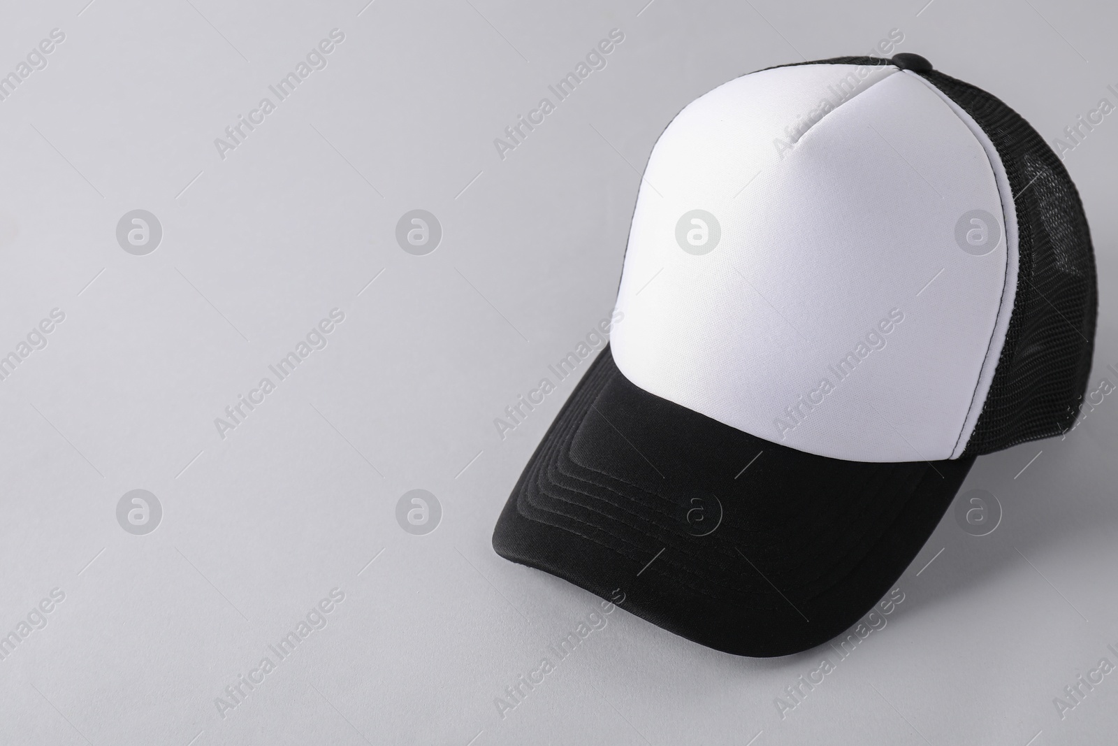 Photo of Stylish baseball cap on light grey background. Mockup for design