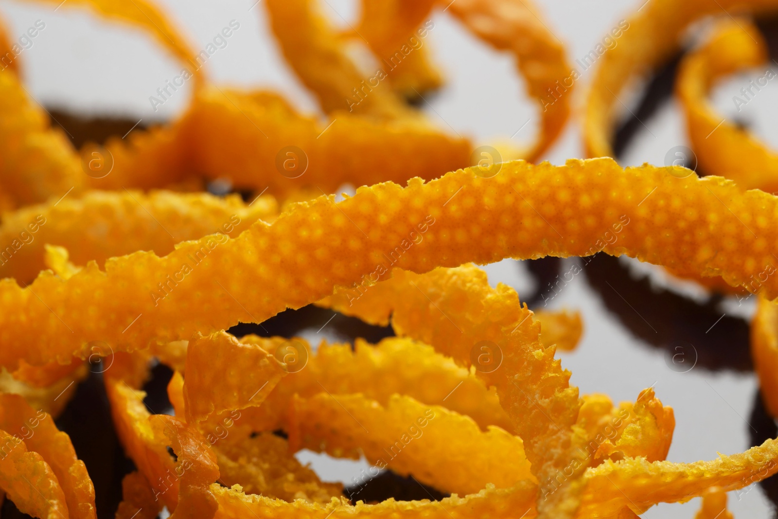 Photo of Pile of fresh orange zest on plate, closeup