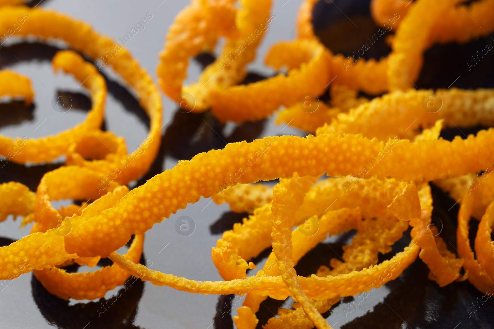 Photo of Pile of fresh orange zest on plate, closeup