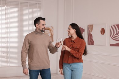 Couple enjoying art and sparkling wine in gallery