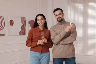 Couple enjoying art and sparkling wine in gallery