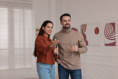 Couple enjoying art and sparkling wine in gallery