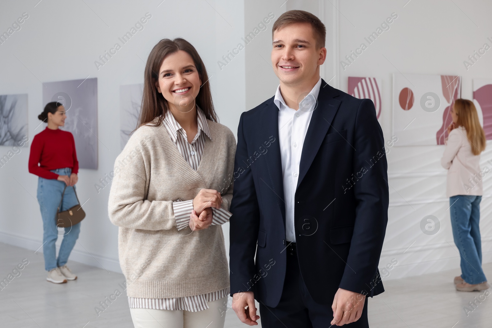 Photo of Happy woman and man visiting art gallery