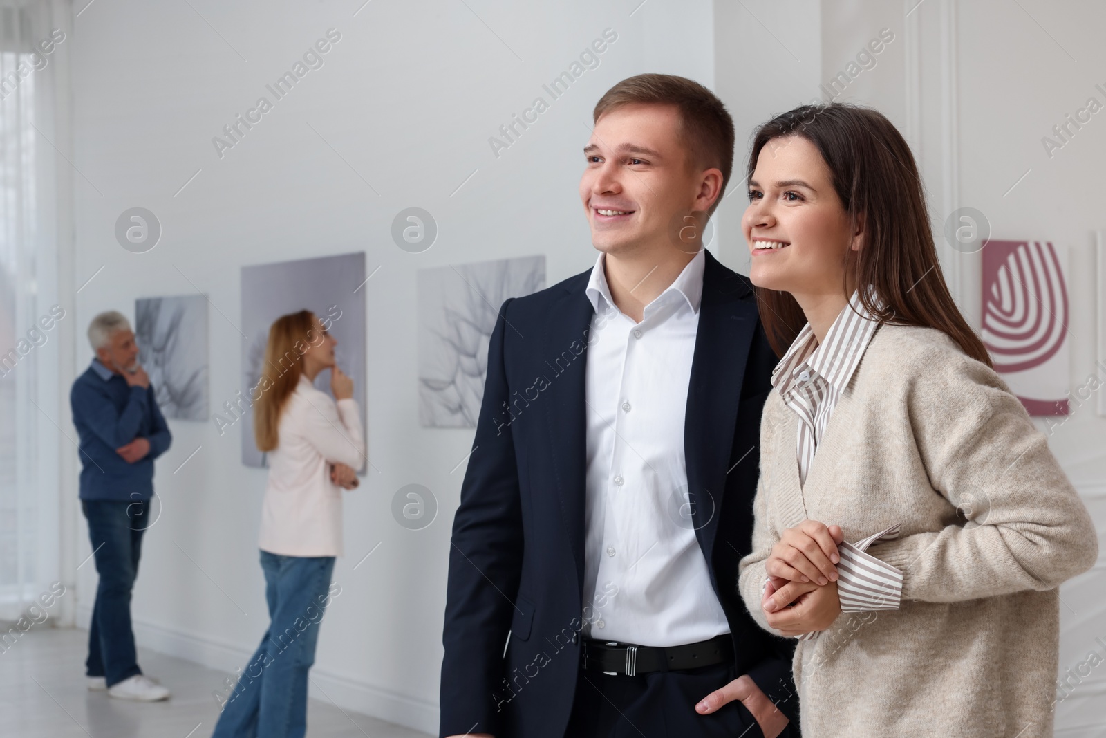 Photo of Happy woman and man visiting art gallery