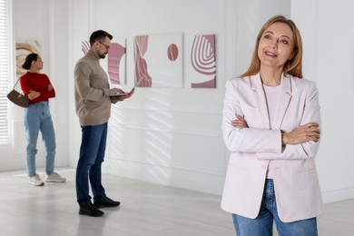 Photo of Beautiful woman enjoying art in modern gallery