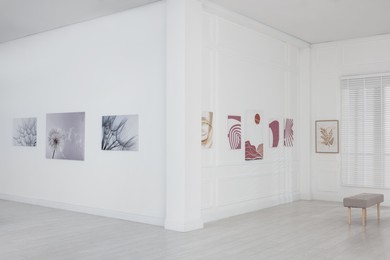 Photo of Interior of modern art gallery with beautiful paintings