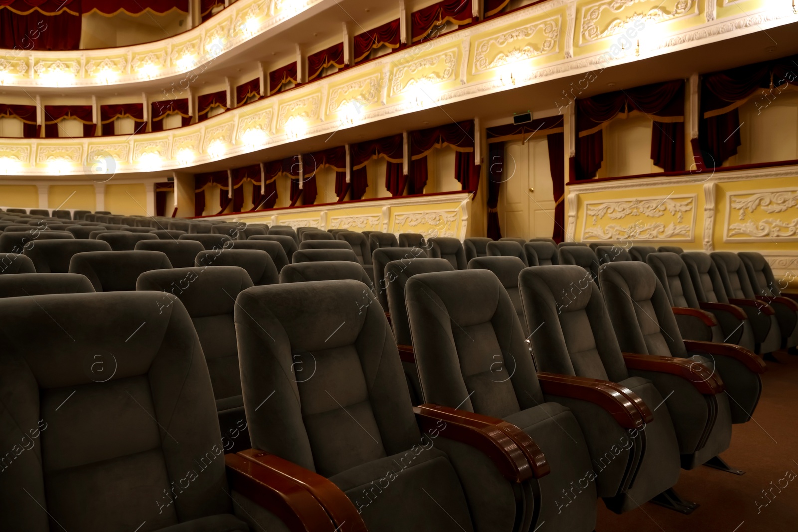 Photo of Rows of gray comfortable seats in theatre, closeup