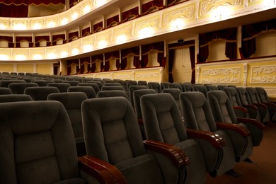 Photo of Rows of gray comfortable seats in theatre, closeup