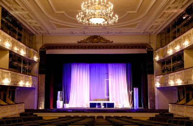 Photo of Theatre interior with stage and rows of comfortable seats