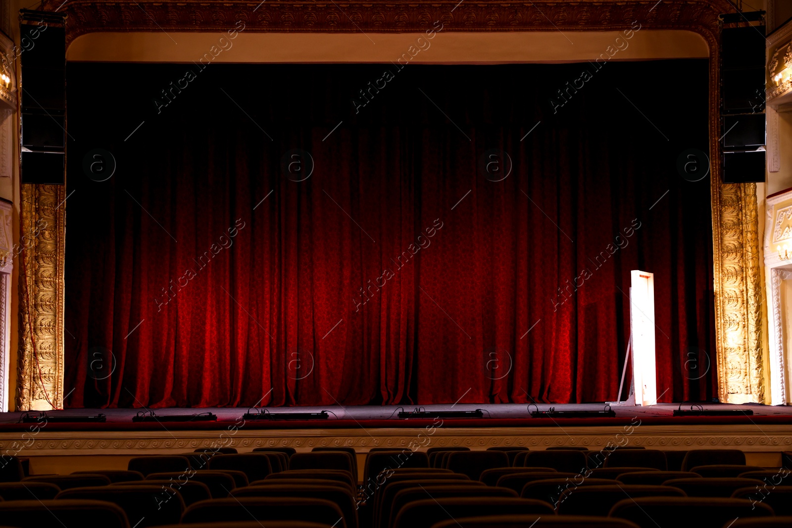 Photo of Theatre interior with stage and rows of comfortable seats