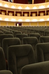 Photo of Rows of gray comfortable seats in theatre, closeup