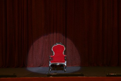 Photo of Vintage red armchair on stage in theatre