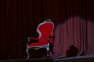 Photo of Vintage red armchair on stage in theatre