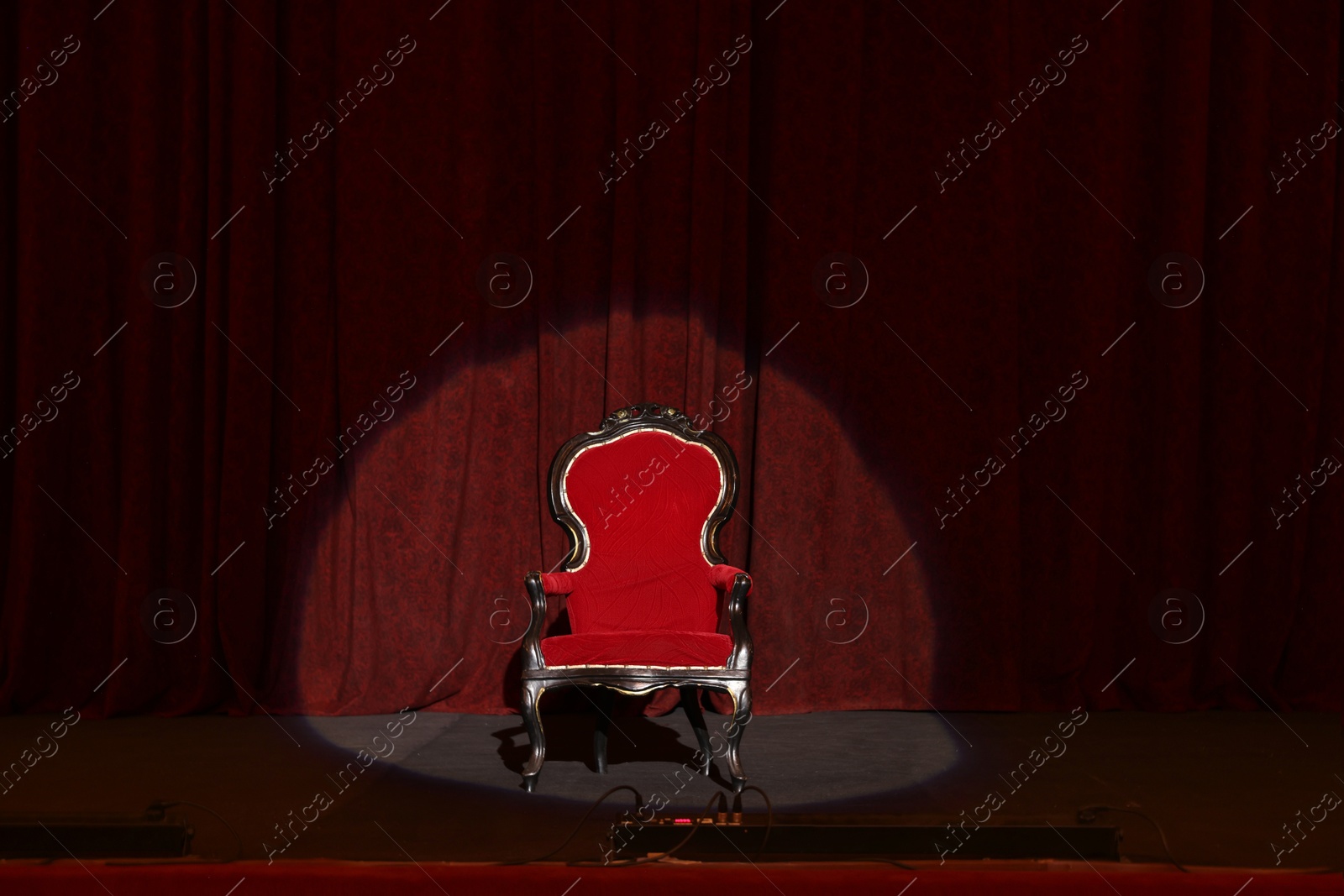 Photo of Vintage red armchair on stage in theatre