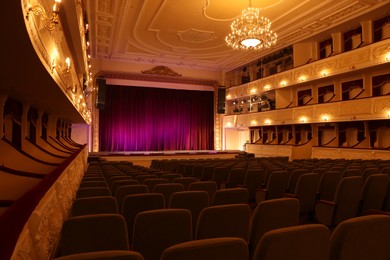 Photo of Theatre interior with stage and rows of comfortable seats